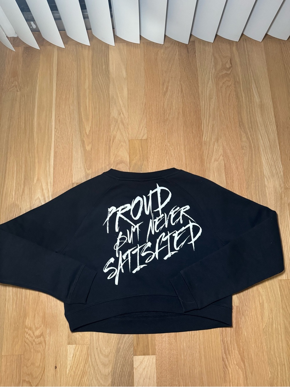 ALPHALETE- Black Graphic Crewneck Sweater - 'Proud But Never Satisfied'